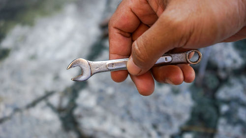 Close-up of hand holding cigarette