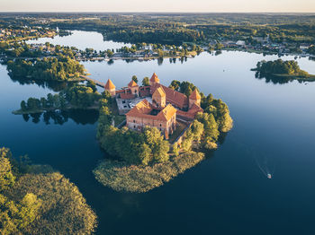 High angle view of lake by buildings against sky