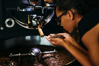 Woman holding roasted coffee beans