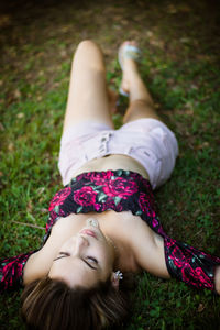 High angle view of woman lying on field