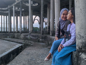 Rear view of mother and daughter in park