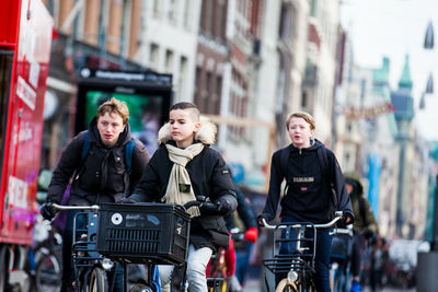 Young man with bicycle on street in city