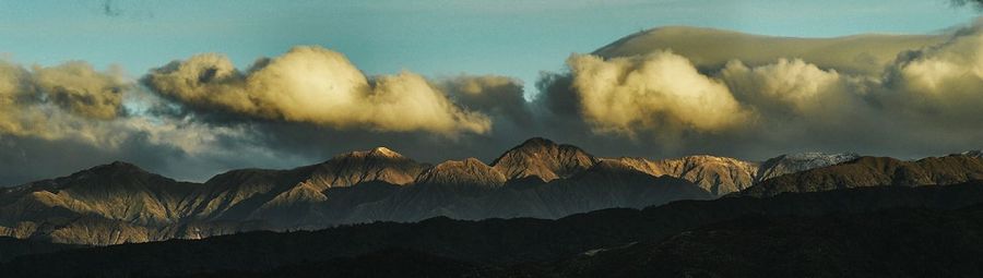 Scenic view of mountains against cloudy sky