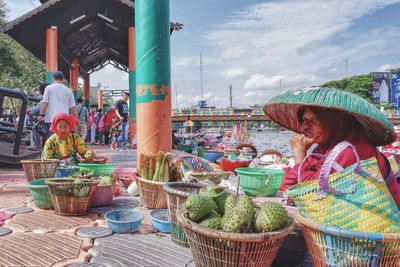 People waiting for sale at market stall