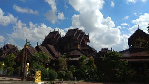 Low angle view of temple amidst buildings against sky