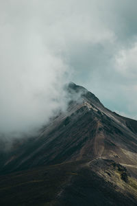 Scenic view of volcanic mountain against sky