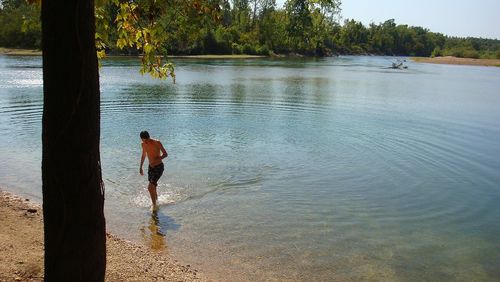 Rear view of shirtless man on beach