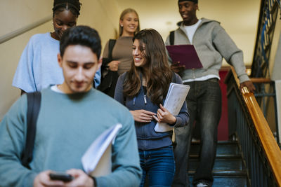 Business colleagues using smart phone