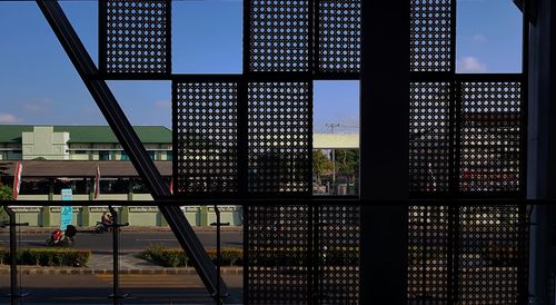 Modern building against sky seen through glass window