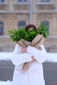 Midsection of woman holding plant