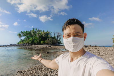 Portrait of man on beach against sky