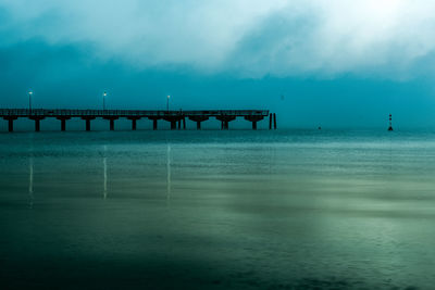 Pier over sea against sky