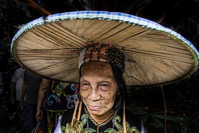 Close-up of senior woman wearing large traditional hat