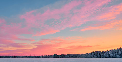 Scenic view of field against romantic sky at sunset