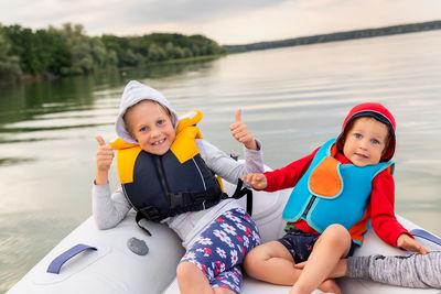 Portrait of brother and sister sitting in boat