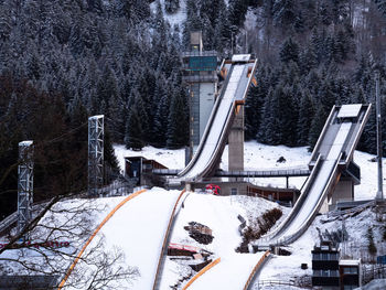 High angle view of snow covered road amidst trees