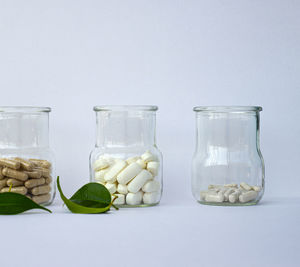 Close-up of drink in glass jar on white background