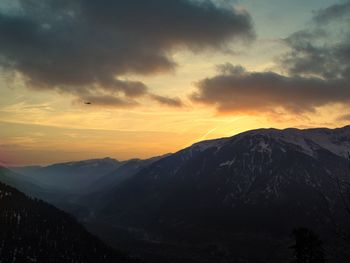 Scenic view of silhouette mountains against sky during sunset