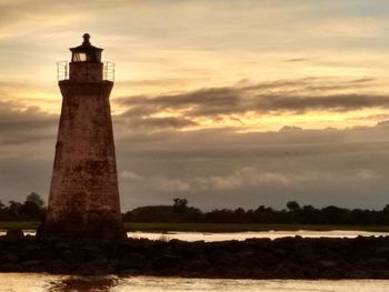 Lighthouse against sky during sunset