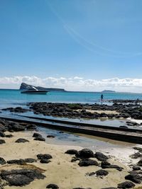 Scenic view of sea against blue sky