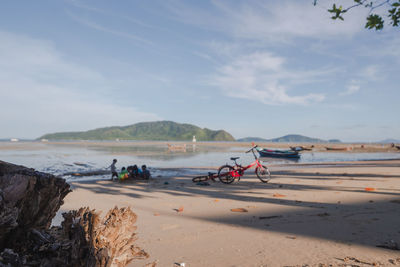 Asian children digging and playing on the beach