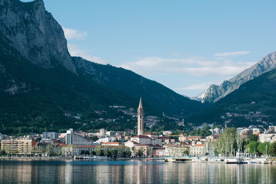 Buildings at waterfront against sky