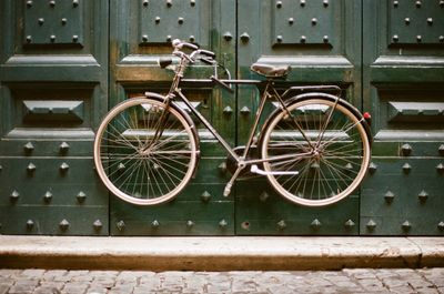 Close-up of bicycle against wall