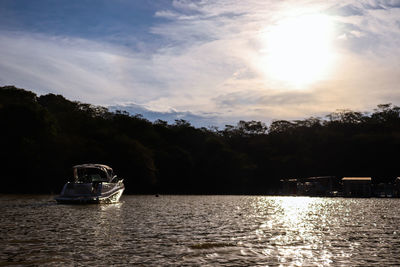 Boat sailing on river against sky