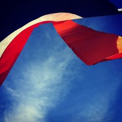 Low angle view of red wall against blue sky