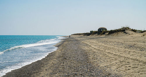 Scenic view of beach against clear sky