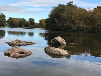 Reflection of rocks in calm lake