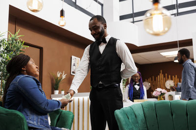 Full length of young man standing in store