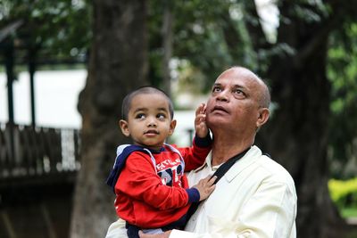 Grandfather and grandson looking up