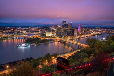 High angle view of illuminated buildings in city at night