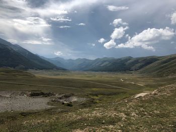 Scenic view of landscape and mountains against sky