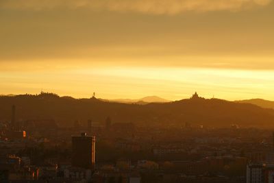High angle view of buildings in city against sky during sunset