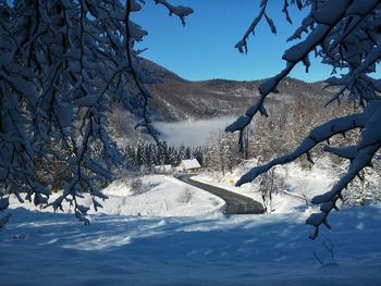 Scenic view of snow covered mountains against sky