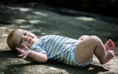 Cute boy lying on ground