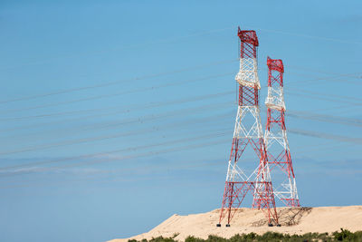 Low angle view of electricity pylon against sky