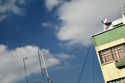 Low angle view of bird perching on building