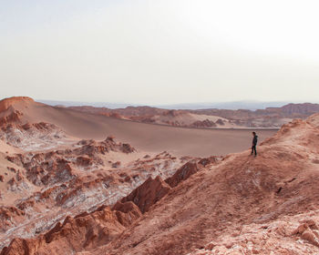 Man at sand dunes at atacama desert, chile