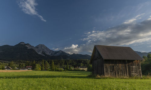 Scenic view of field and mountains against sky