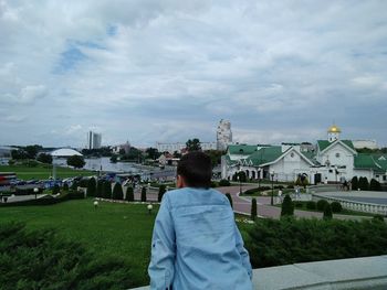 Rear view of woman looking at city buildings