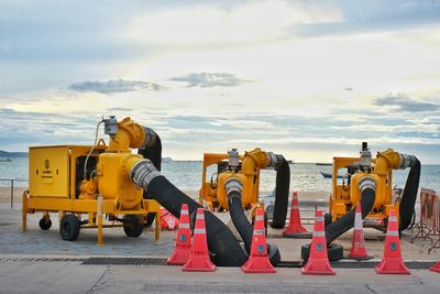 Construction site by road against sky