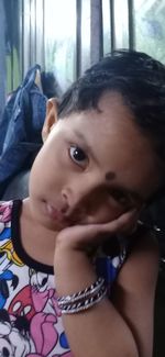 Close-up portrait of baby girl at home