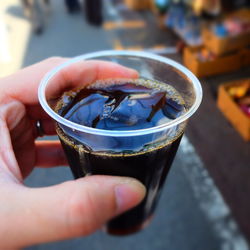 Close-up of hand holding drink