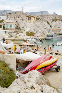 Boats moored on beach against sky