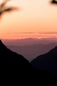 Scenic view of silhouette mountains against sky during sunset