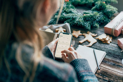 Midsection of woman using mobile phone