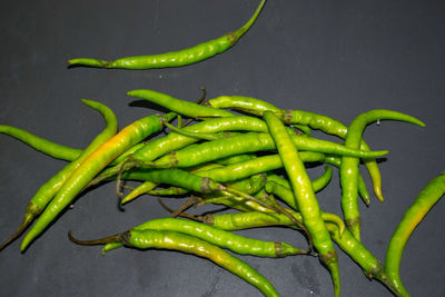 High angle view of green chili peppers on table